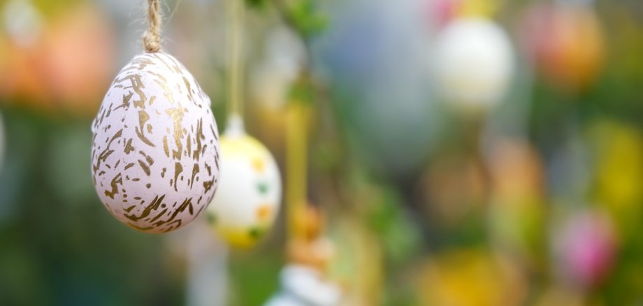 Ostereier in Großaufnahme an einem Ast hängend