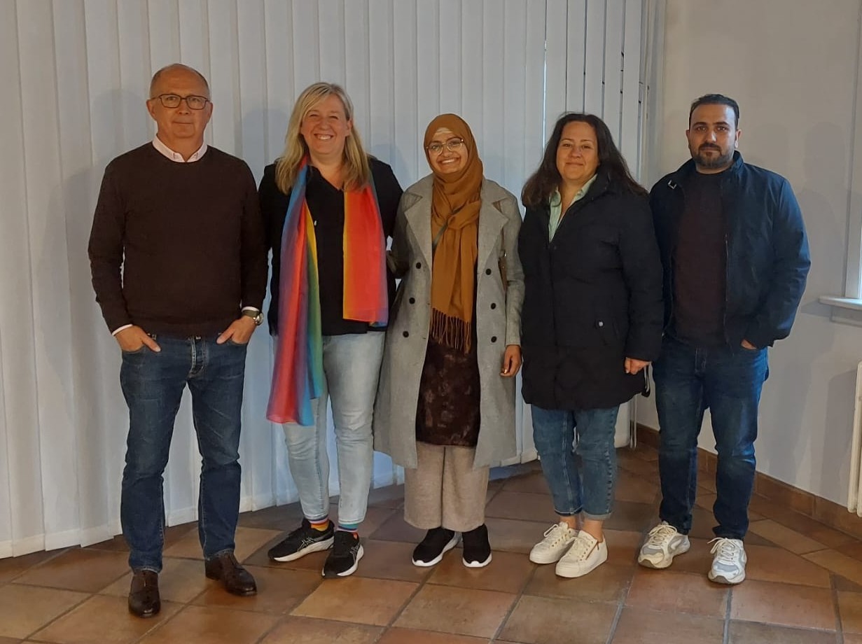 Der Ausländerbeirat, bestehend aus fünf Personen (2 Männer und 3 Frauen) stehen nebeneinander und lächeln in die Kamera.